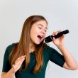 A portrait of a girl singing with a microphone