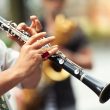 Detail of a street musician playing the clarinet.